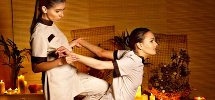 woman pulling patient shoulder and arms back