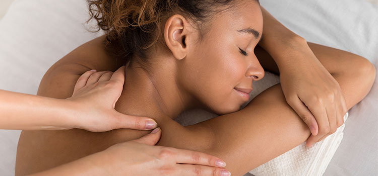 reclining content patient having neck and shoulder rub