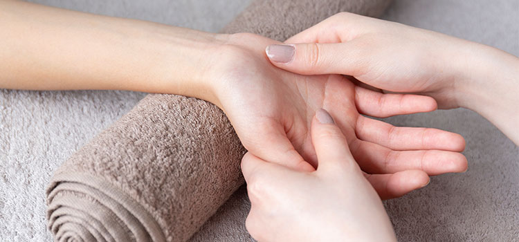 hand being massaged by woman