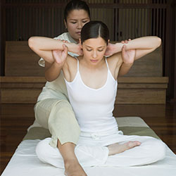 woman works on patients arms and shoulders