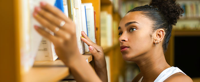 woman doing research in college library