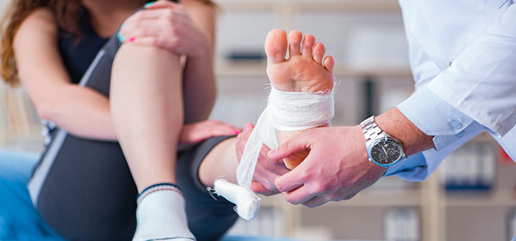 athletic trainer treats foot injury