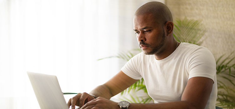 male athletic training student studies on computer