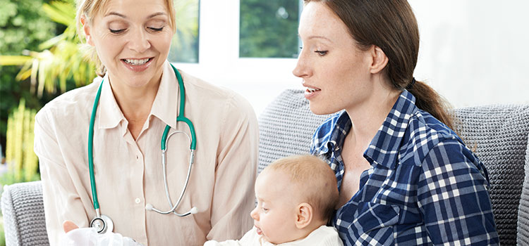midwife shows new mother with baby empty bottle