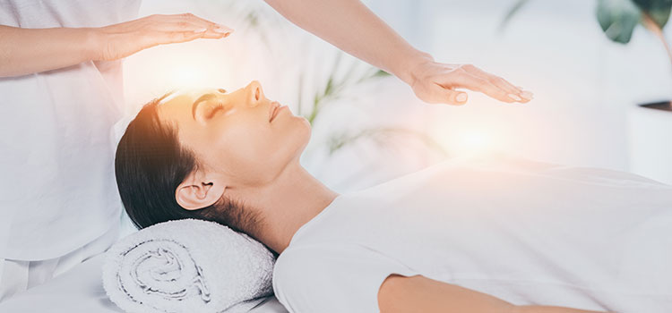 polarity therapy session with hands over patient