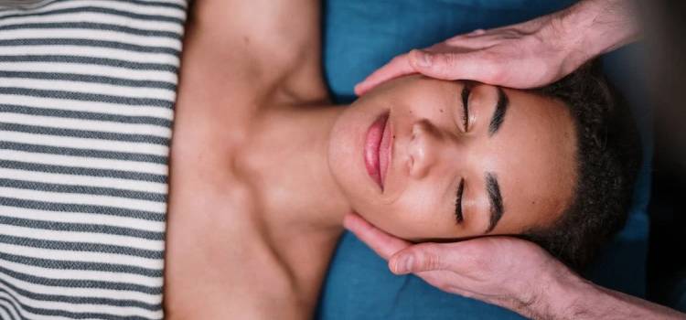 bioenergetic practitioner soothing patients cheeks with two hands