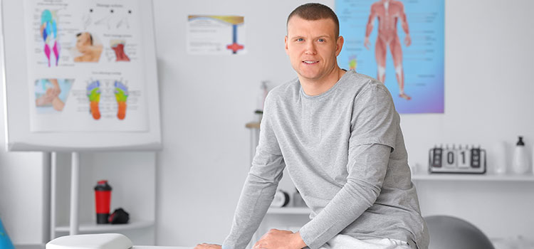 male massage therapist in office