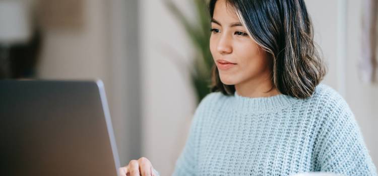 female student looking at computer deep in thought