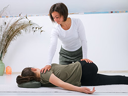 woman applying acupressure to client