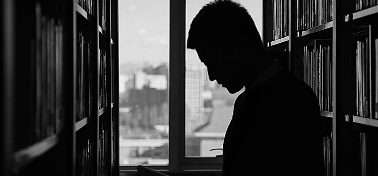 person reading a book in a library