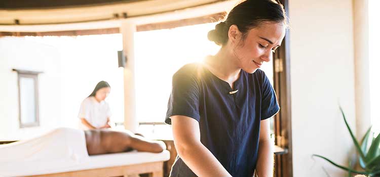 woman working as massage therapist in spa
