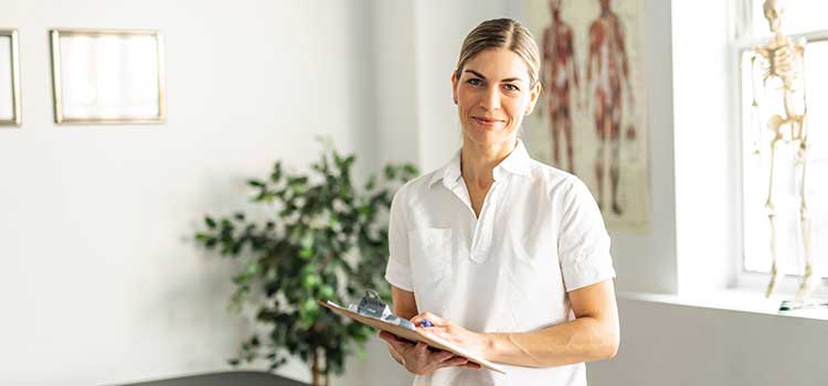 female pt holds clipboard