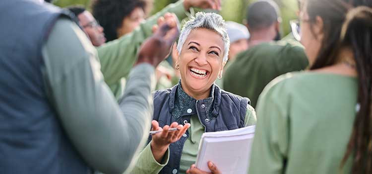 smiling community health worker polls crowd