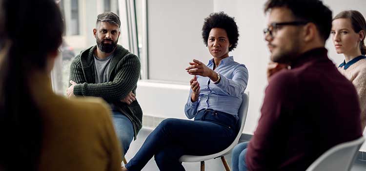 female social worker calls on member of group during session