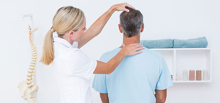 chiropractor adjusts clients neck and top of spine