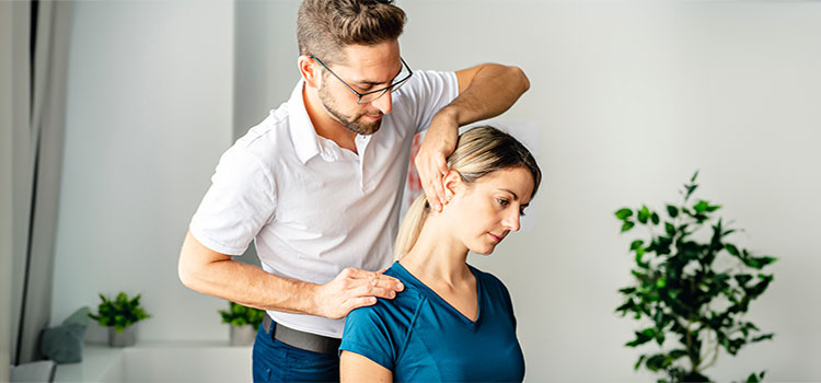 georgia chiropractor stretches woman patient neck and shoulder